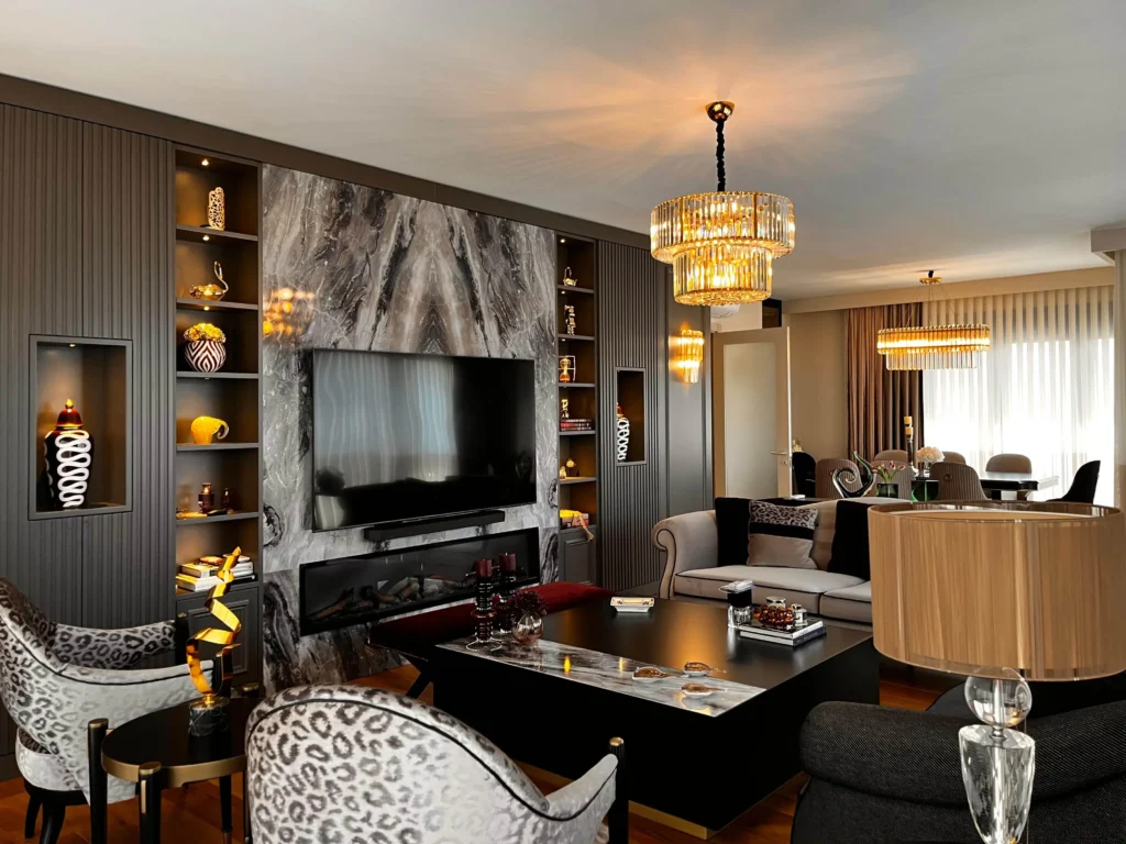 Penthouse living room decoration with a fireplace and large marble accent wall.