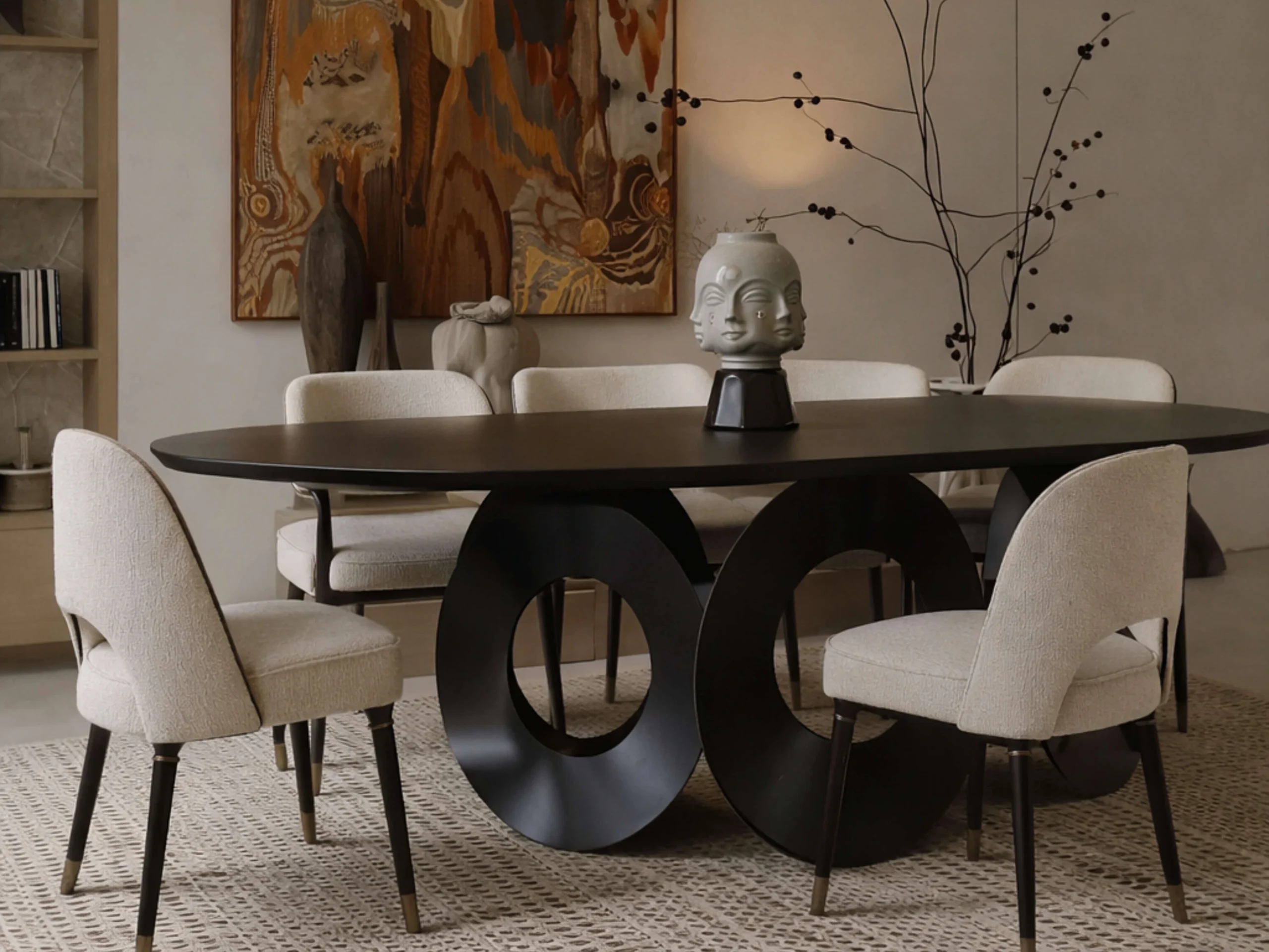 Avant-garde black oval dining table with contemporary upholstered chairs.