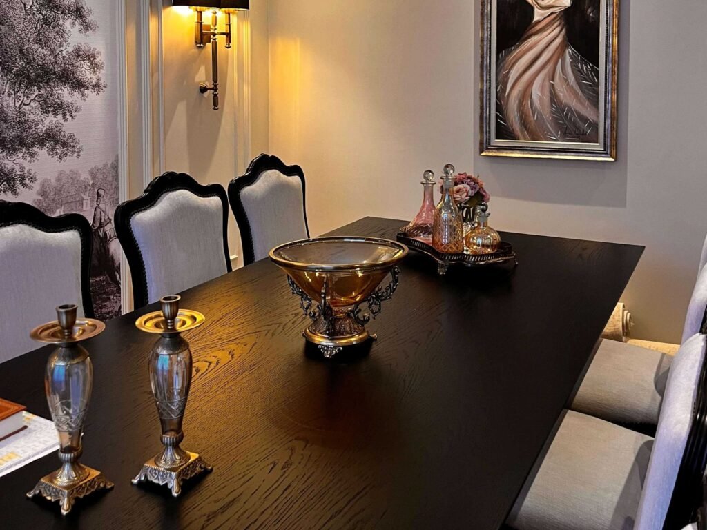Elegant dining hall decoration featuring a classic dark wood table and silver candelabras.
