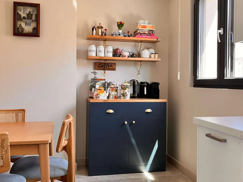 Deep blue kitchen cabinetry featuring a natural wood countertop coffee nook.